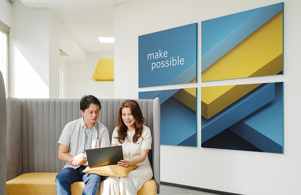 employees looking at computer laptop